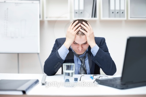 Depressed young businessman holding his head at office (178628720) - 게티 ...