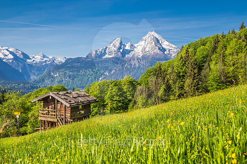 Idyllic spring landscape in the Alps with traditional mountain lodge ...