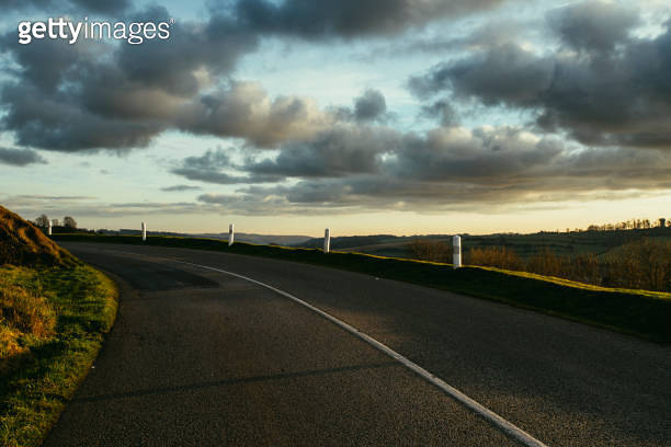 Asphalt curved road passing through the fields in the region of ...