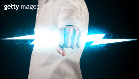 Business man holding glowing lightning bolt in his hands (948499068 ...