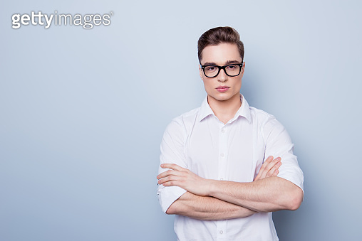 Close up portrait of handsome young man in white shirt and glasses ...