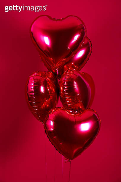 Heart shaped helium inflated red foil air balloon flying in the air ...