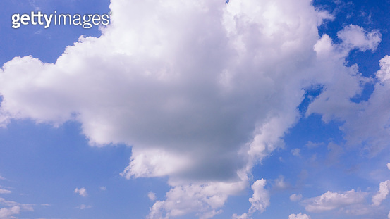 Beautiful bright blue sky with white fluffy clouds on a clear sunny day ...