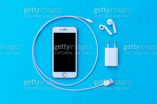 Top view plastic white wireless Apple AirPods, charging, smartphone iphone  8, iphone 7, iphone 6, Lighning