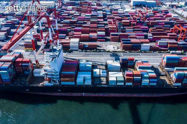 A large cargo ship loaded with many containers is fixed in the ...