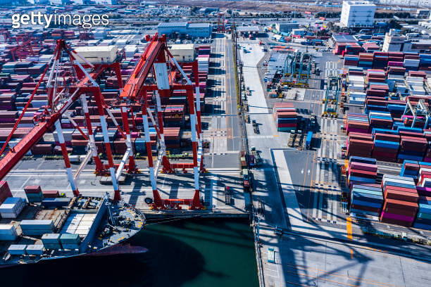 A large cargo ship loaded with many containers is fixed in the ...