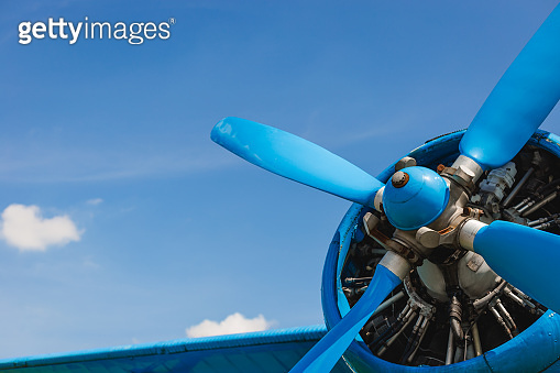 Close up abstract of a vintage airplane propeller engine against blue ...