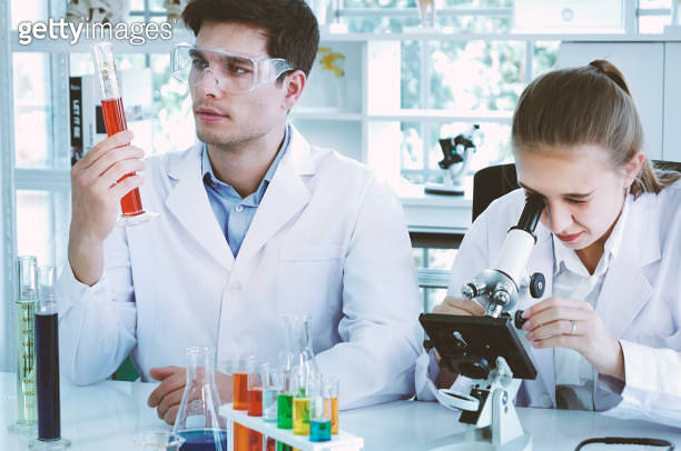 Health care researchers working in life science laboratory. Young ...