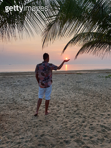 Chumphon Thailand, guywatching sunset on the beach in Thailand, men on