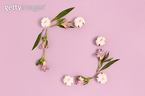 Square frame made of alstroemeria flowers, cotton and green leaves ...