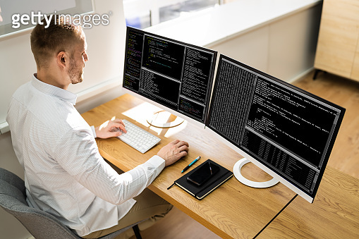Computer Programmer Writing Program Code On Computer (1322669318) - 게티이미지뱅크