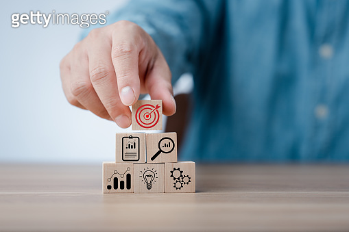 Hand arranging wood block stacking with business strategy and Action ...