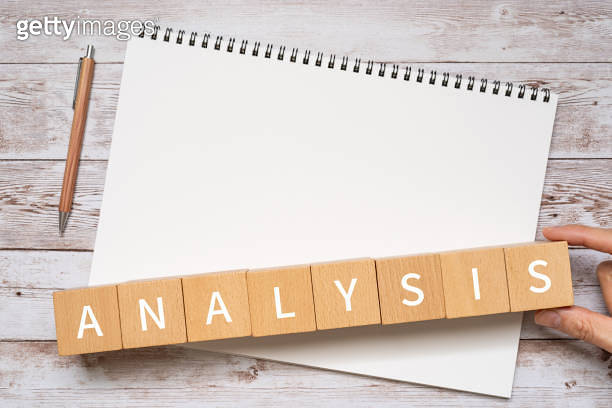 Wooden blocks with "ANALYSIS" text of concept, a pen, and a notebook ...
