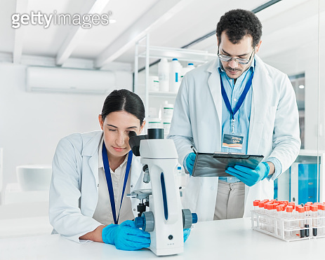 Shot of two young scientists working together in a lab (1388152217 ...