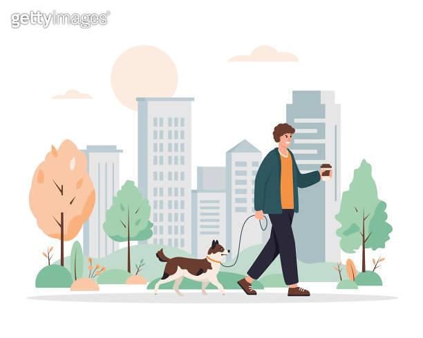 Young man walking with dog in city park. Guy with cute dog on leash and ...