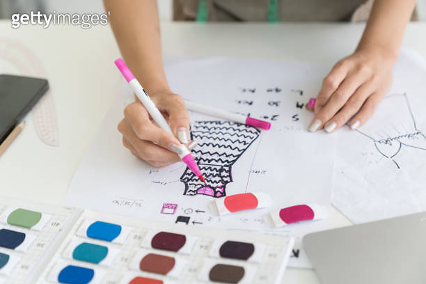 Hands of female dressmaker design fabric dress in sewing workshop ...