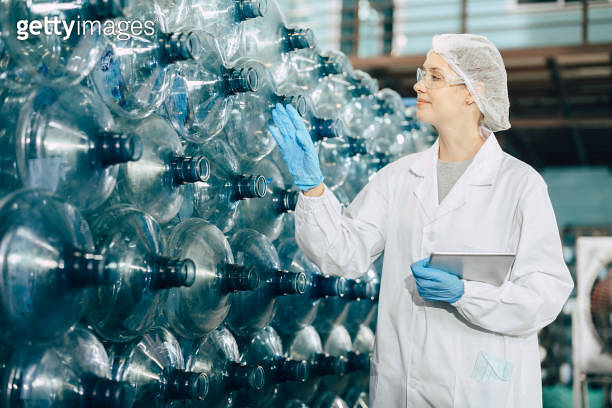 women worker working in drinking water plant factory checking count ...