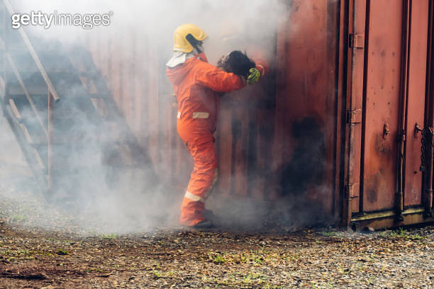 Firefighter to save girl in fire and smoke. Rescue Team or Firefighters ...