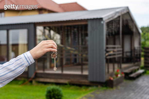 Hand holding keys to new house. Moving relocation concept, real estate ...