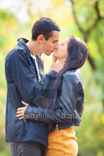 couple-kissing-outdoor-in-the-park-182256454