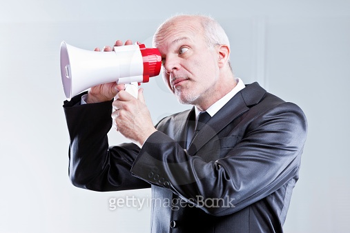 man using a megaphone with eyes instead of mouth 이미지 (522893391) - 게티이미지뱅크