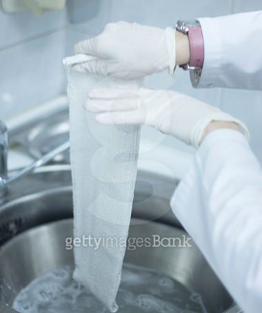 Doctor applying a plaster cast and bandages to patient forearm and ...