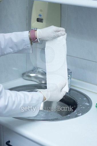 Doctor applying a plaster cast and bandages to patient forearm and ...