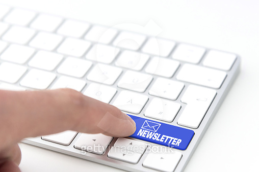finger pressing a blue key labeled NEWSLETTER with envelope symbol on a ...