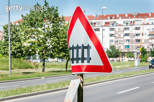 Damaged and distorted railway sign with railroad crossing road symbol ...