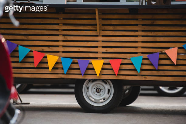 wheels and bottom part of food truck with colorful flags 이미지