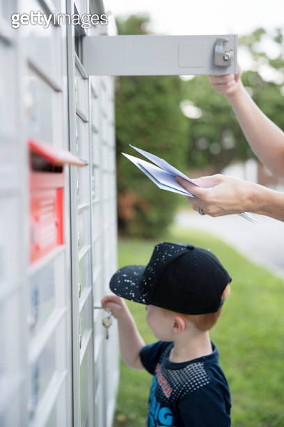 Woman hand Picking up the Mail at Postal Mailbox with Young Boy 이미지 ...