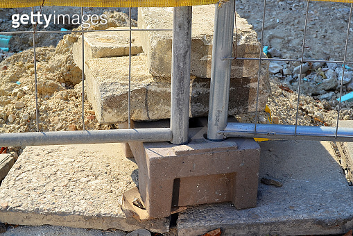 Fragment of the lower part of the metal fence racks around the ...