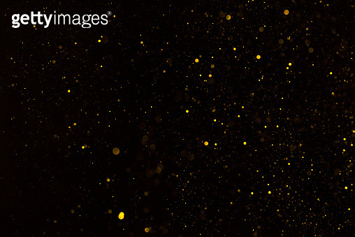 Golden glitter particles falling on black background 이미지 (1137028755 ...