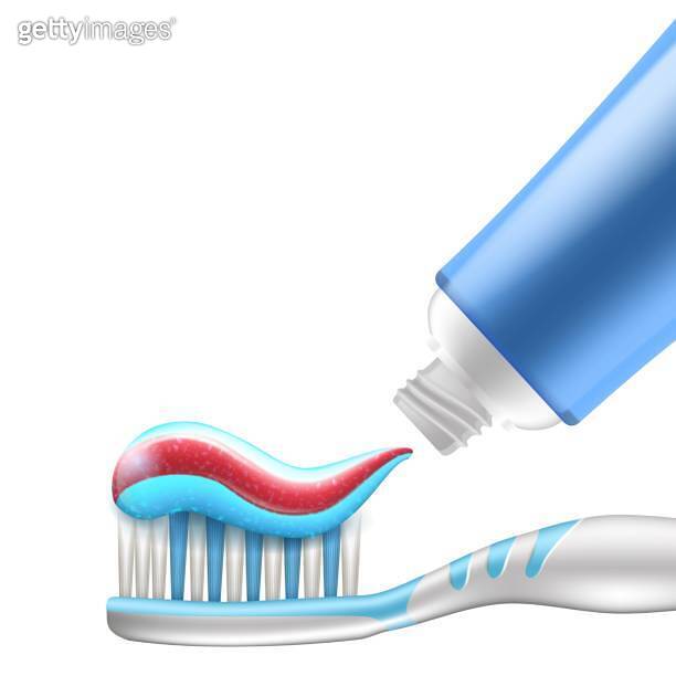 The toothpaste being applied to the nylon bristles of toothbrush head