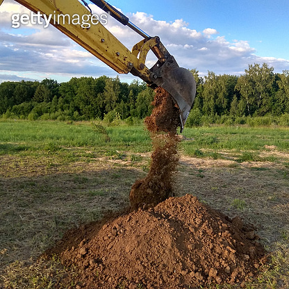 a work excavator digging a trench for the foundation of a building 이미지 ...