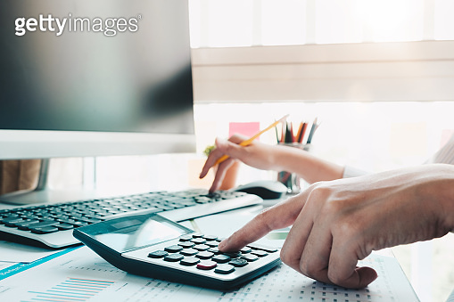Accountant hand holding pen working on calculator to calculate business ...