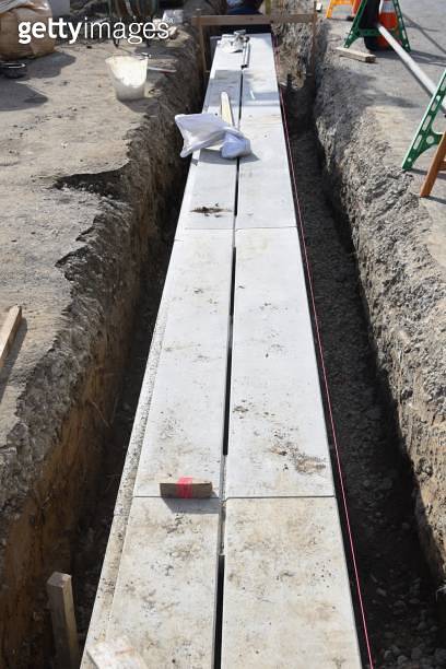 Installation construction of street gutter on the road. (1192165728 ...