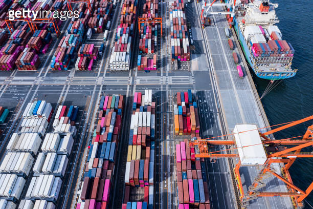 A large cargo ship loaded with many containers is fixed in the ...
