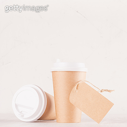 Coffee packing mockup - two craft brown paper cups, blank white caps ...