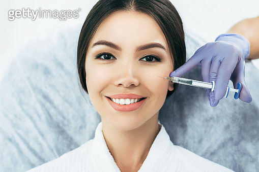 asian woman getting rejuvenation injection for fresh skin. Staying ...