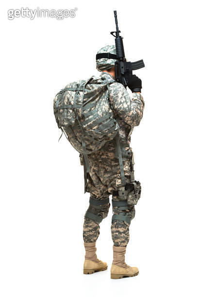 Rear view / back of armed forces / army soldier / hero standing in the ...