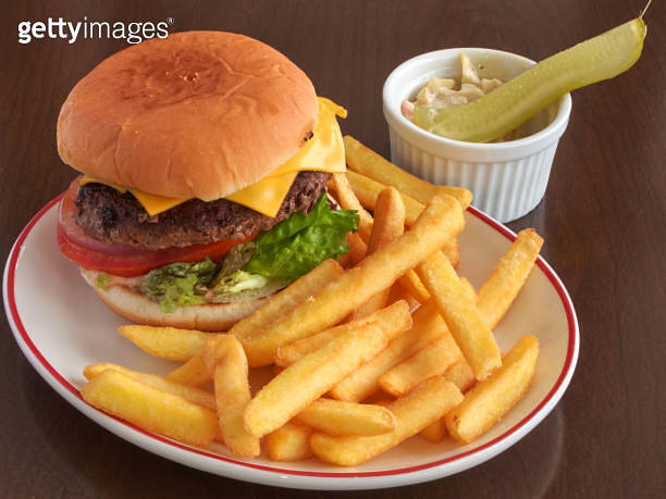 Gourmet handmade beef burger with fries, cole slaw, and pickled ...