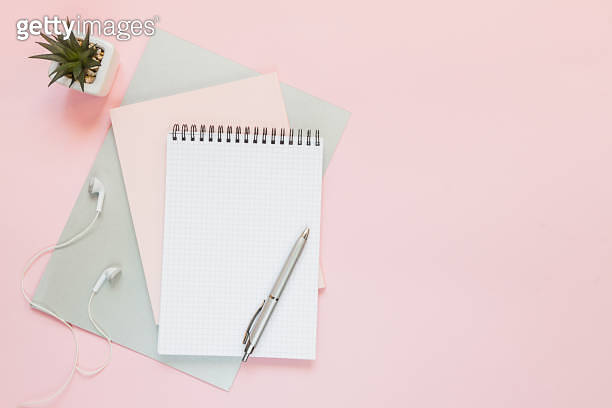Top view of a flat lay of desktop and notepads for writing down goals ...