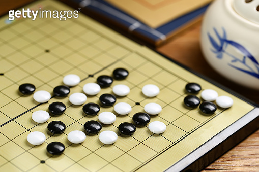 Chinese go game board, close up view of playing black and white stone ...