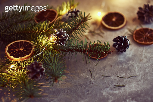 Christmas decorations with garland lights, pine cones and fir tree ...