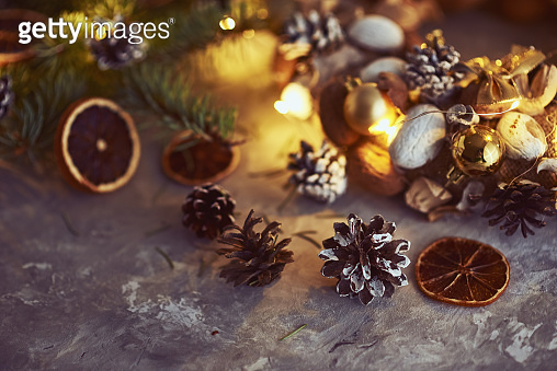 Christmas decorations with garland lights, pine cones and fir tree ...