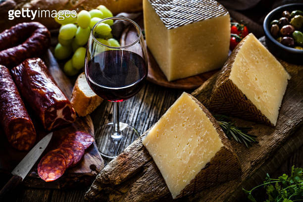 Spanish food: Manchego cheese, spanish chorizo, red wine and olives on ...