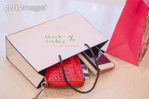 Online shopping concept with smartphone and credit Bank cards, black