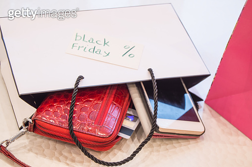 Online shopping concept with smartphone and credit Bank cards, black