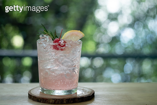 Pink cocktail with lychee syrup and sparkling soda decoration with ...